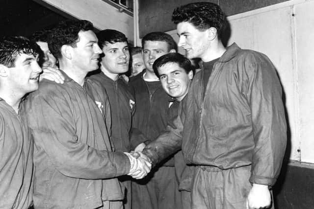Tam Preston shaking hands with a new Hibs signing, goalkeeper Jack Reilly. Picture: TSPL