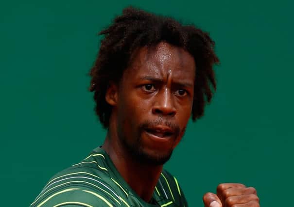 Gael Monfils celebrates during his win over Roger Federer. Picture: Getty