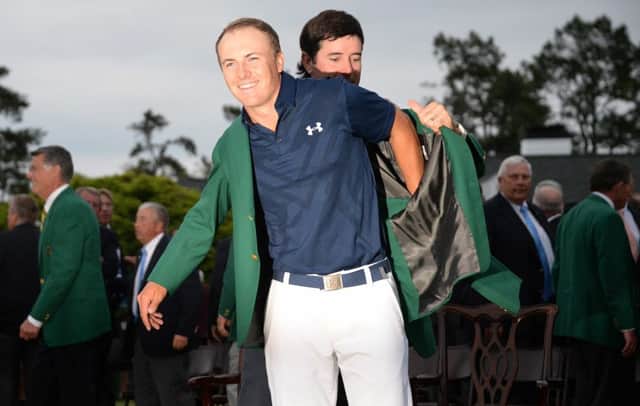 Bubba Watson helps Jordan Spieth put on the Masters' Green Jacket. Picture: AFP/Getty