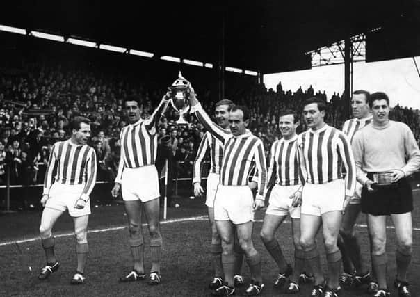 Kilmarnocks £25-a-week players with the 1964-65 league trophy. The title was won with a 2-0 victory against red-hot favourites Hearts at Tynecastle. Picture: Contributed