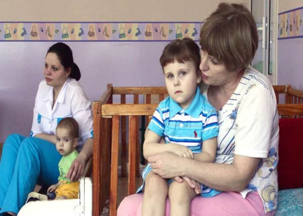 Nurses at Antoshka Orphanage with two of the children who are under 24-hour supervision due to their fragile physical state. Picture: Abed al Qaisi