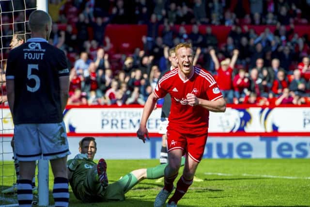 Aberdeen's Adam Rooney celebrates after putting his side 1-0 up. Picture: SNS
