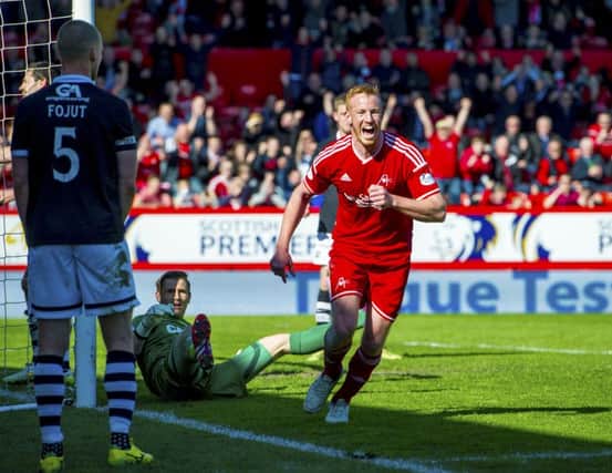 Aberdeen's Adam Rooney celebrates after putting his side 1-0 up. Picture: SNS