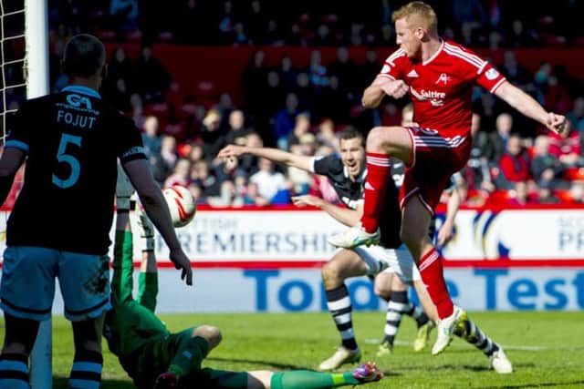 Aberdeen's Adam Rooney (right) knocks it in to put his side 1-0 up. Picture: SNS
