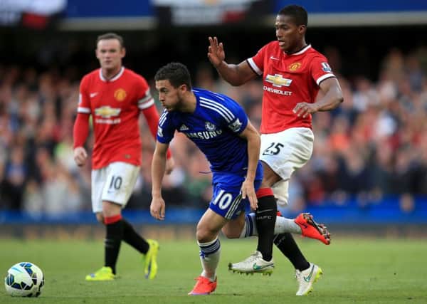 Manchester Uniteds Antonio Valencia, right, battles Chelsea scorer Eden Hazard for the ball at Stamford Bridge. Picture: Nick Potts/PA