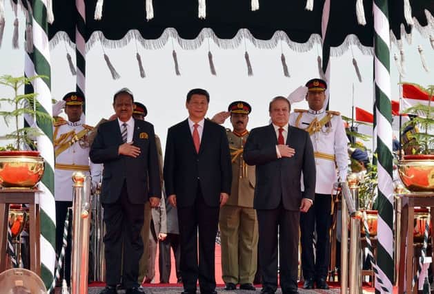 Chinese President Xi Jinping flanked by Pakistani counterpart Mamnoon Hussain, left, and Prime Minister Nawaz Sharif. Picture: Getty