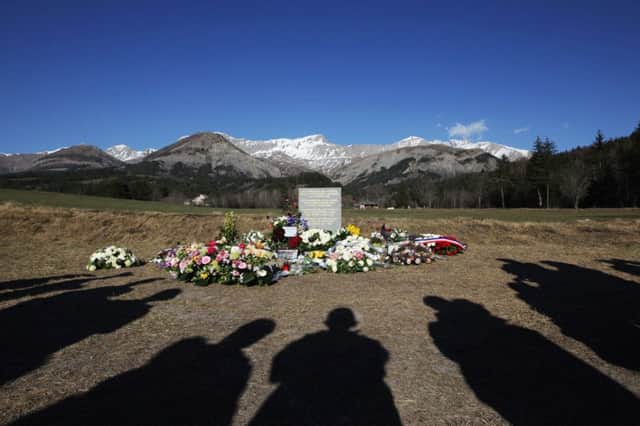 People gather around a memorial to the 150 killed in the Germanwings Airbus A320 crash in the French Alps on 24 March. Picture: Getty