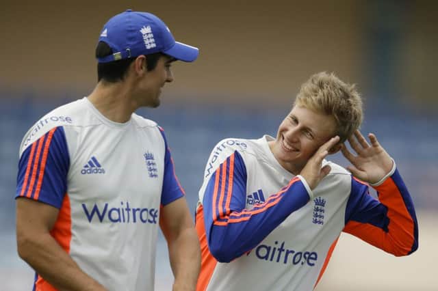 England captain Alastair Cook, left, talks to Joe Root during practice. Picture: AP