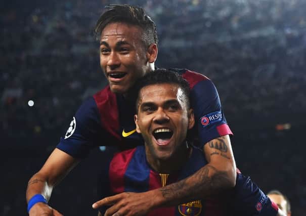Neymar celebrates with Daniel Alves after scoring his second goal of the night. Picture: Getty