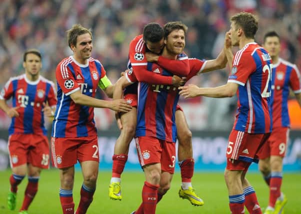 Xabi Alonso celebrates with his teammates as Bayern put the finishing touches on the 6-1 thumping of Porto. Picture: Getty