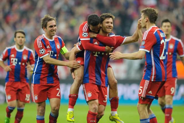 Xabi Alonso celebrates with his teammates as Bayern put the finishing touches on the 6-1 thumping of Porto. Picture: Getty