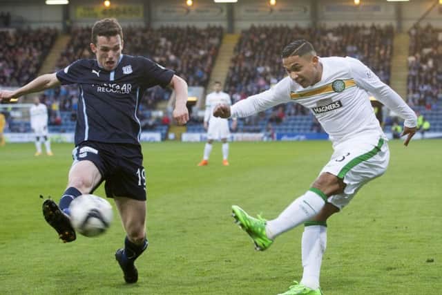 Emilio Izaguirre gets a yard on Dundee's Paul McGinn as Celtic returned to winning ways following Sunday's controversial defeat. Picture: PA