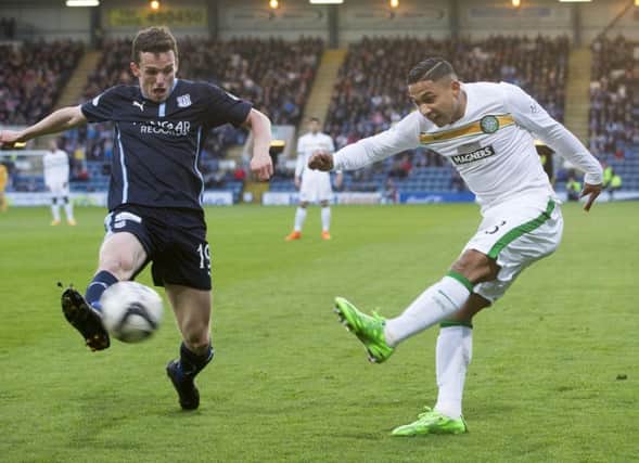 Emilio Izaguirre gets a yard on Dundee's Paul McGinn as Celtic returned to winning ways following Sunday's controversial defeat. Picture: PA