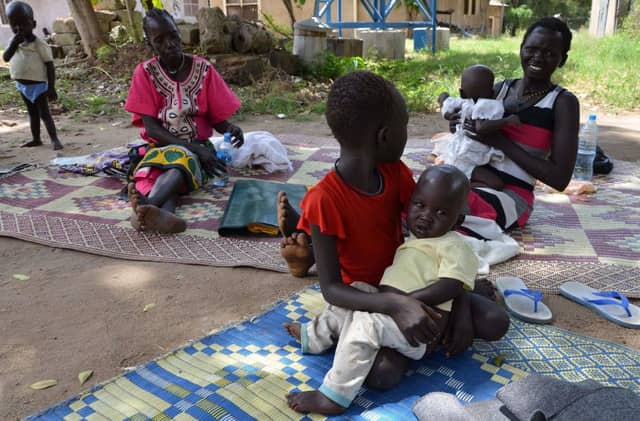 A girl holds her brother who is being treated for malaria. Picture: Getty