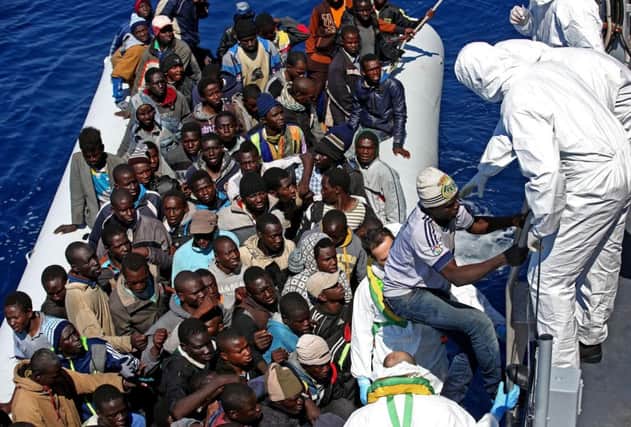 Migrants on an overcrowded boat in the Mediterranean are rescued. Picture: AP