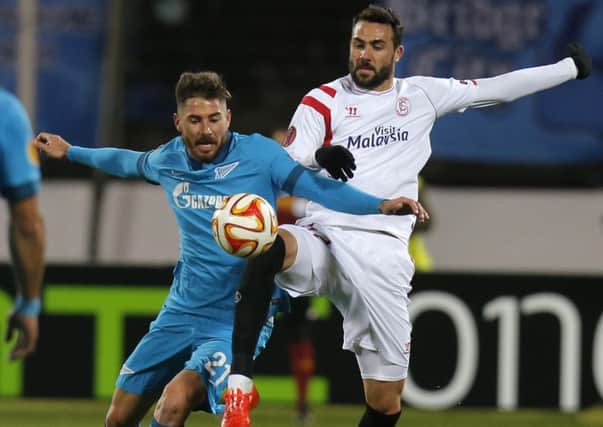 Zenits Javi Garcia (L)  fights for the ball with Sevilla's Vicente Iborra. Picture: AP
