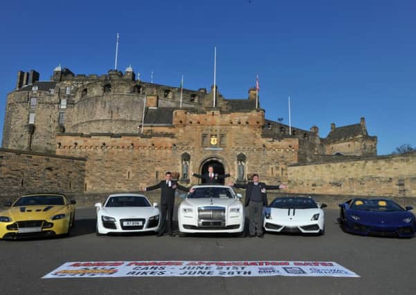 Veterans Stephen McLachlan, Royal Engineers, Sam Cochrane, Royal Engineers and George Aitken BEM, Royal Army Service Corps, stand alongside a variety of supercars on display, at Edinburgh Castle