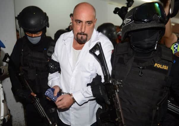 Serge Areski Atlaoui is escorted by armed police commandos following a court hearing last month. Picture: Getty
