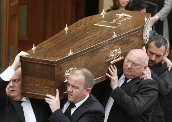 The coffin of former Labour MSP Tom McCabe is carried from St Mary's Church in Hamilton. Picture: PA
