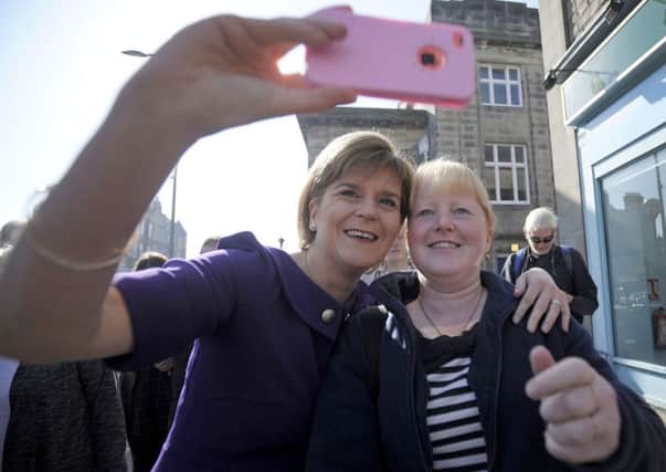 First Minister Nicola Sturgeon takes a selfie photograph with a supporter in the  Portobello area of Edinburgh. The SNP, in a new study, are shown to be surging ahead of their rivals on Twitter. Picture: Getty
