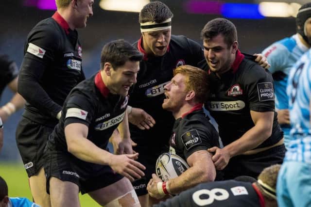 Edinburgh players congratulate Roddy Grant after the flanker opened the try-scoring last night. Picture: SNS