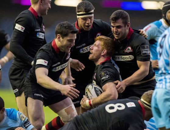 Edinburgh players congratulate Roddy Grant after the flanker opened the try-scoring last night. Picture: SNS