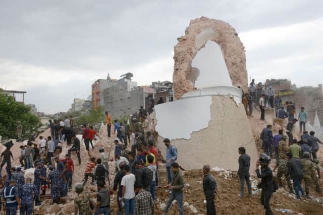 Nepalese rescue members gather at the collapsed Darahara Tower. Picture: Getty