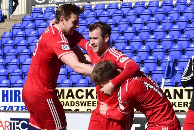 Northern Ireland international Niall McGinn, centre, celebrates putting the Dons ahead. Picture: SNS