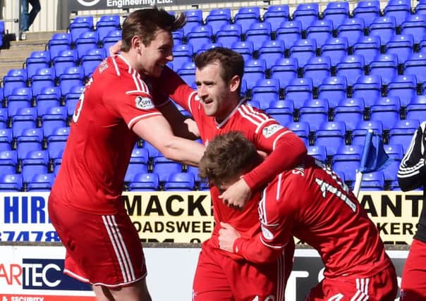 Northern Ireland international Niall McGinn, centre, celebrates putting the Dons ahead. Picture: SNS
