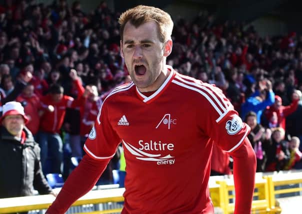 Aberdeen's Niall McGinn wheels away in celebration having hammered the ball home to put his side ahead. Picture: SNS