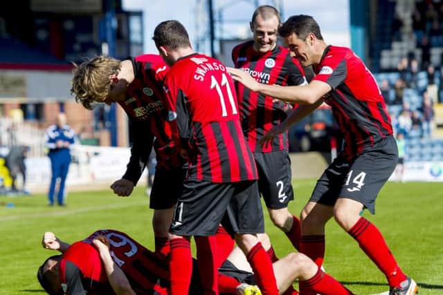 St Johnstone players celebrate after Dundee's Ian Davidson lets in an own goal. Picture: SNS