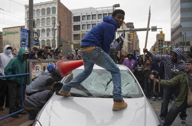 Protesters wreck a police patrol car as anger spills over. Picture: Getty