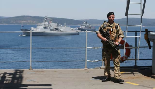 A Royal Navy sailor stands guard aboard HMS Bulwark off the Turkish coast yesterday. Picture: PA