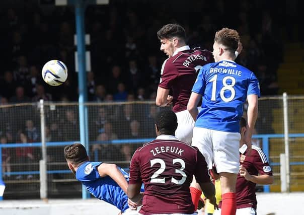 Callum Paterson, playing as a target man, rises highest to head home Hearts equaliser. Picture: David Lamb