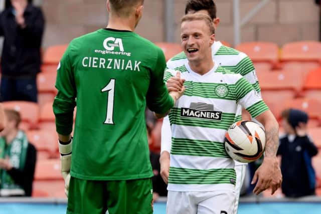 Leigh Griffiths shakes hands with Dundee United goalkeeper Radoslaw Cierzniak. Picture: SNS