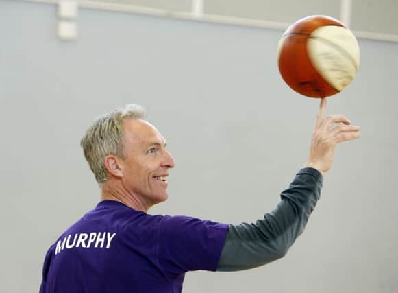 Jim Murphy shows off his basketball skills at Holy Rood RC High School in Edinburgh yesterday. Picture: PA