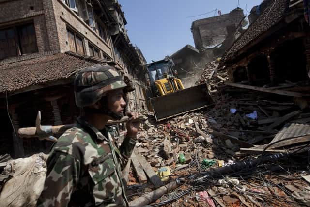 A member of the Nepalese army walks through a damaged area caused by Saturday's earthquake, in Bhaktapur on the outskirts of Kathmandu. Picture: AP