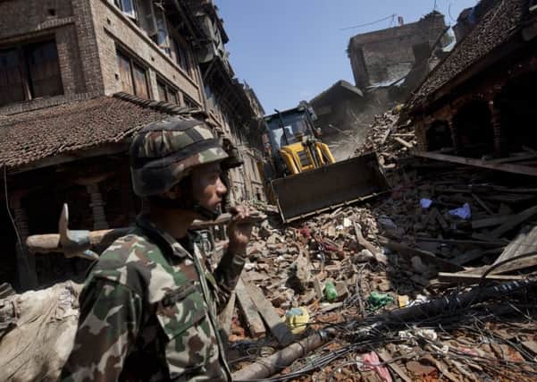 A member of the Nepalese army walks through a damaged area of Kathmandu. Picture: AP