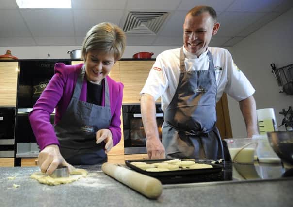 First Minister Nicola Sturgeon, with chef Andy Beattie, bakes scones during a visit to The Cook School in Kilmarnock, Ayrshire. Picture: Getty