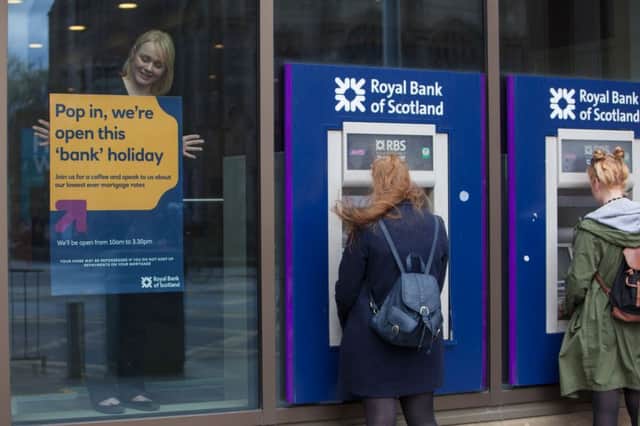 Branch Manager Lynsey Watson puts up a poster in the RBS West End Branch on Princes Street, Edinburgh. Picture: Toby Williams