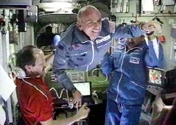 On this day in 2001 space station commander Yury Usachev, left, welcomed millionaire Dennis Tito, centre, on board. Picture: AP