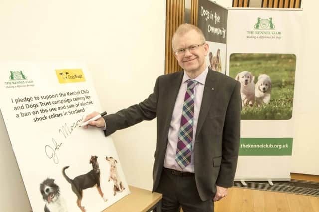 The SNP's John Mason MSP signs a pledge in favour of banning the shock collars. Picture: Peter Devlin