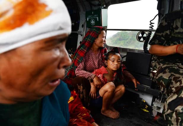 Injured Nepalese villagers sit inside an Indian Army helicopter after being evacuated. Picture: Getty