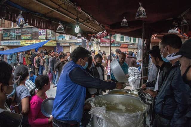 Volunteers serve food to Kathmandu residents. Picture: Getty