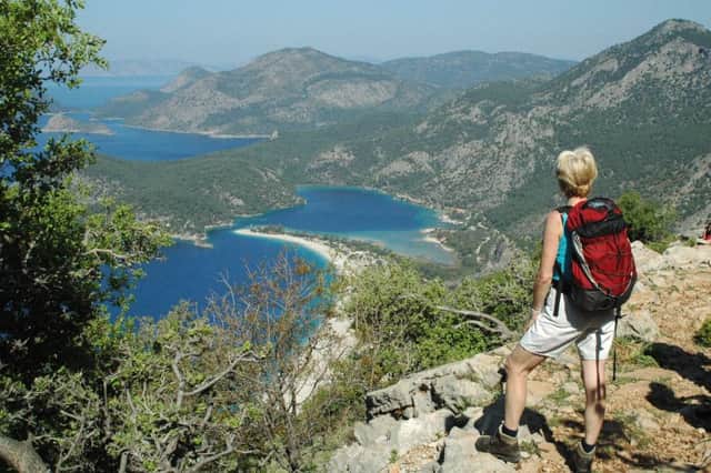A walker stops to admire the view of Oludeniz beach on The Lycian Way, Turkey's Turquoise Coast