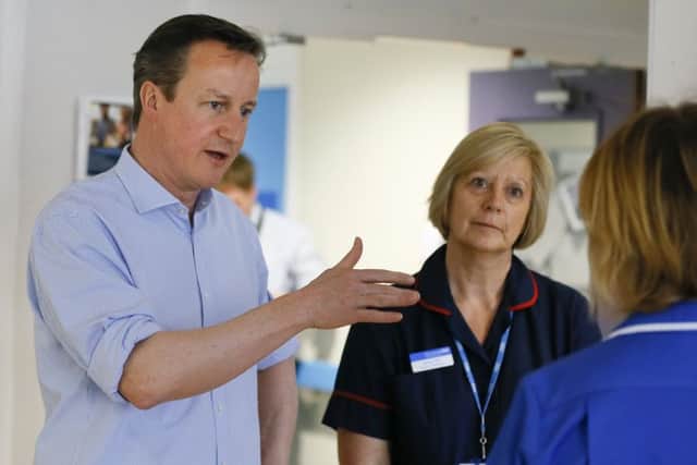 David Cameron at an English hospital, whose future can be hit by SNP MPs. Picture: Getty