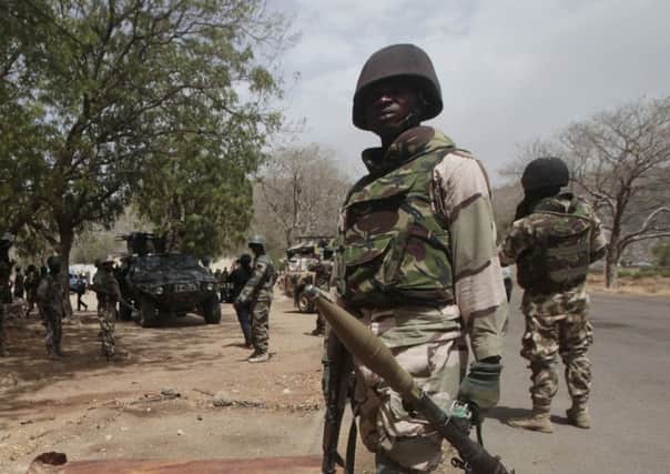 Nigerian soldiers man a checkpoint in a liberated town. Picture: AP