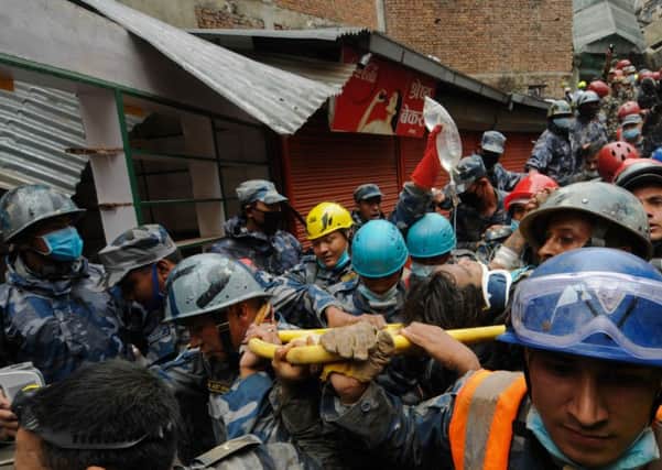 Nepalese rescuers carry Pemba Lama, 15, on a stretcher in Kathmandu. Picture: Getty