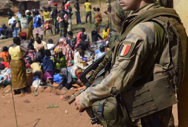 A French soldier stands guard as Muslim people wait to seek refuge at a church in Boali in Central African Republic. Picture: Getty