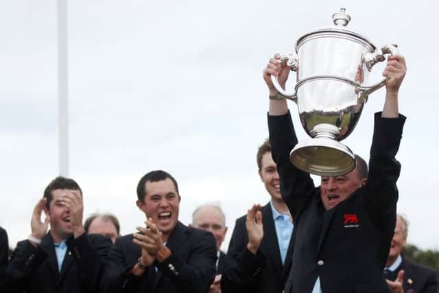Victorious Great Britain & Ireland captain Nigel Edwards lifts the Walker Cup at Royal Aberdeen Golf Club in 2011. Picture: Getty